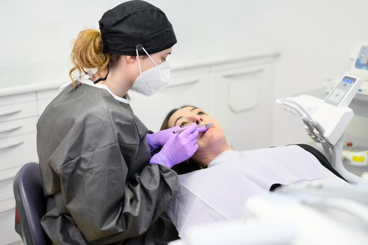 Young dentist working with female patient in a modern hospital. High quality photo