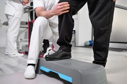 Senior Patient and physical therapist in rehabilitation walking exercises. High quality photo