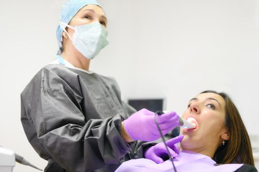 Doctor examining patient's teeth with intraoral camera. High quality photo