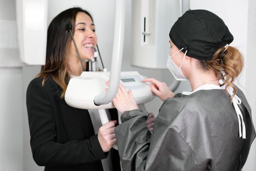 Young woman patient standing in x-ray machine. High quality photo