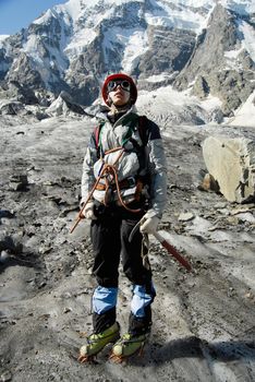 Young mountaineer is standing on a glacier during training courses