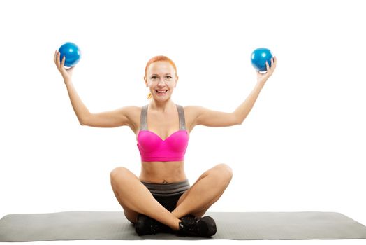 Young slim sensual red woman wearing sports bra practicing fitness