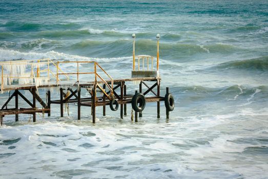 Wooden pier at the sea shore during winter