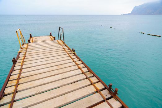 Wooden pier at the sea shore during winter