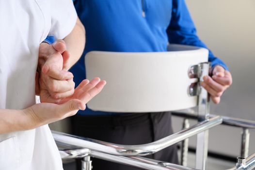 Physiotherapist assisting a patient with Amyotrophic Lateral Sclerosis. High quality photo