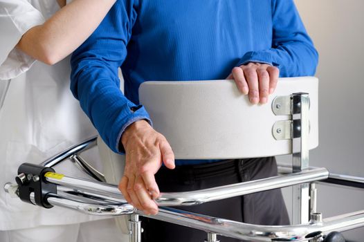 Physiotherapist assisting a patient with Amyotrophic Lateral Sclerosis. High quality photo