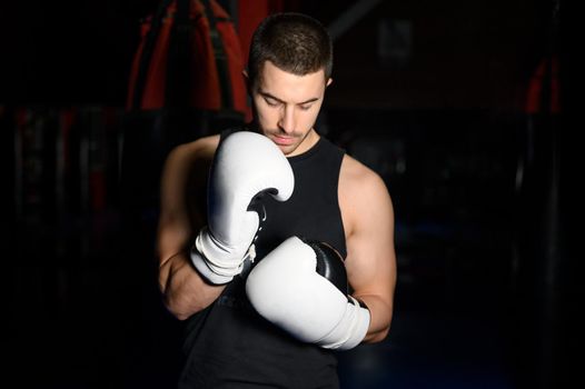 Confident boxer standing in pose and ready to fight. High quality photo