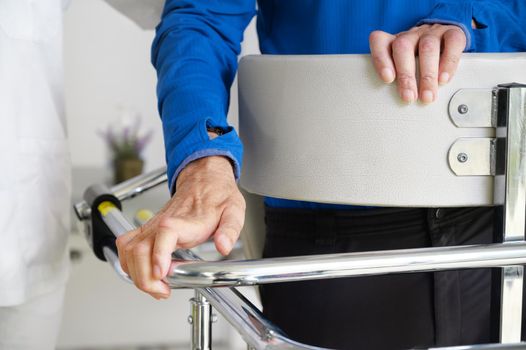 Physiotherapist assisting a patient with Amyotrophic Lateral Sclerosis. High quality photo