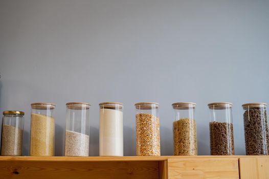 Glass jars with cereals in an eco friendly store. The concept of a grocery store without plastic disposable packaging.