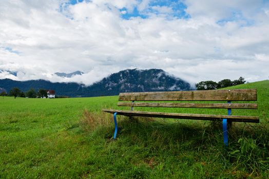 A calm place to rest and relax. An empty wooden bench. Switzerland Alps.