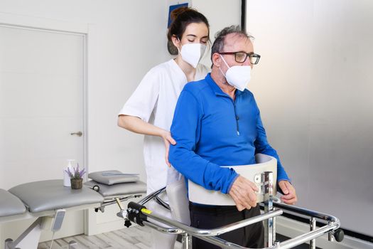 Physiotherapist assisting a patient with Amyotrophic Lateral Sclerosis. High quality photo