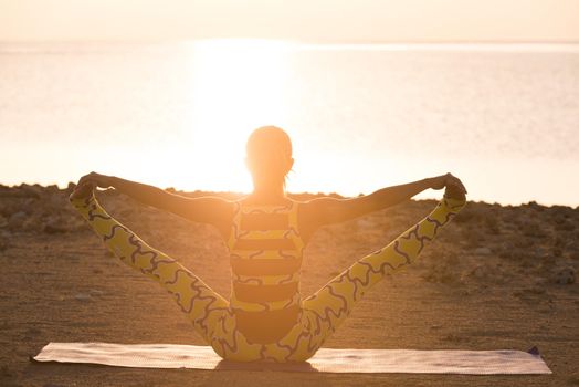 Yoga practice. Woman doing yoga asana at sunrise