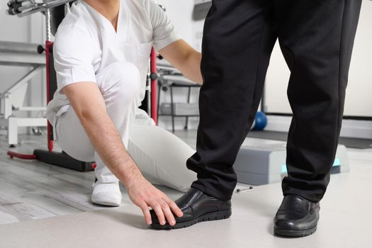 Senior Patient and physical therapist in rehabilitation walking exercises. High quality photo
