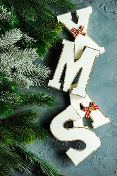 Christmas card concept with wooden lettes made XMAS word and holiday decorations