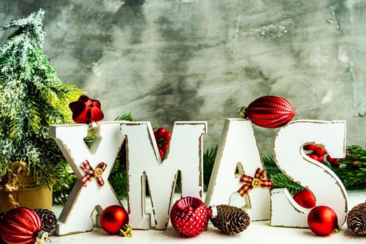 Christmas card concept with wooden lettes made XMAS word and holiday decorations