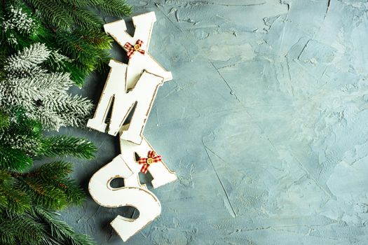 Christmas card concept with wooden lettes made XMAS word and holiday decorations