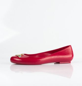 Trendy red ballet shoes shot on plain background
