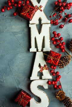 Christmas card concept with wooden lettes made XMAS word and holiday decorations