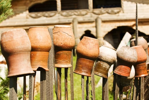 Clay pots put up on a wooden fence