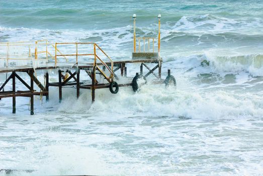 Wooden pier at the sea shore during winter
