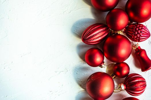 Christmas card concept with variety of holiday festive red balls on concrete background