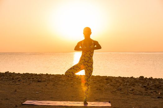 Yoga practice. Woman doing asana at sunrise