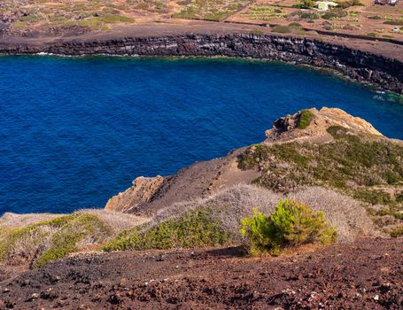 View of the scenic lava rock cliff in the Linosa island. Sicily