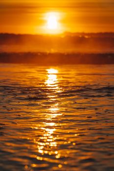 Colorful ocean beach sunrise with deep blue sky and sun rays. High quality photo