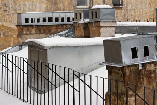 Fragment of the roof of an old house with brick chimneys. Close up