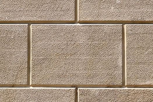 Background from a wall with rectangular beige stone slabs