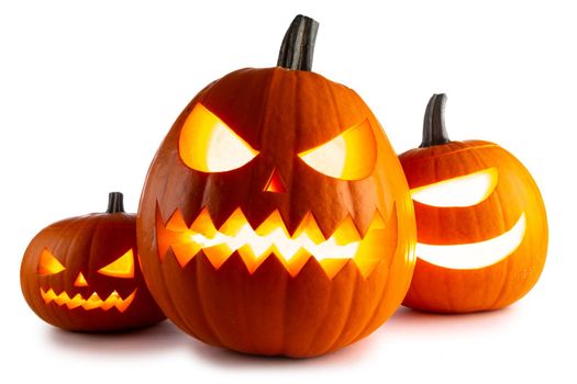 Three glowing Halloween Pumpkin lanterns isolated on white background