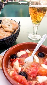 Cold beer, Murcian salad and bread on the terrace of a bar in Spain