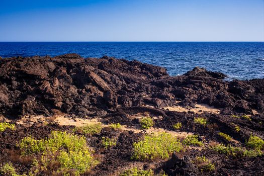 View of the scenic lava rock cliff in the Linosa island. Sicily