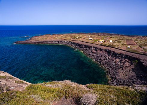 View of the scenic lava rock cliff in the Linosa island. Sicily