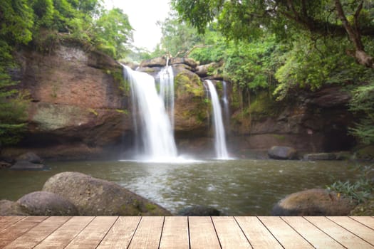 Wooden table with environmental in water fall  forest.