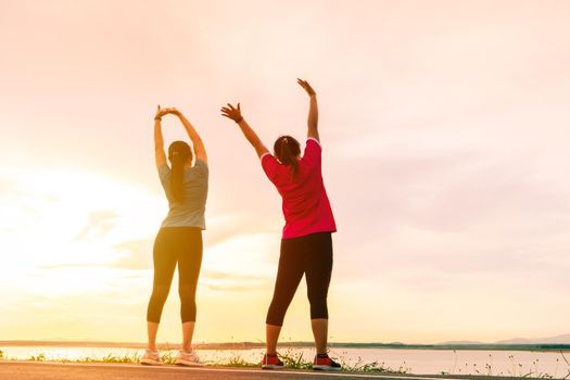 sport women are stretching muscle before workout