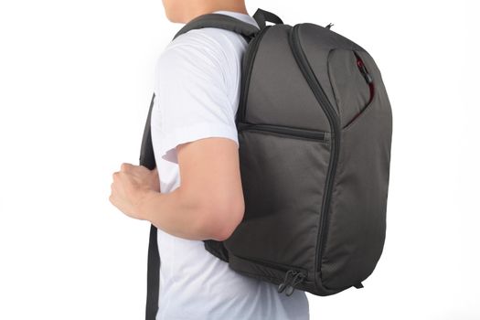 Young man standing with travel backpack equipments isolated white background