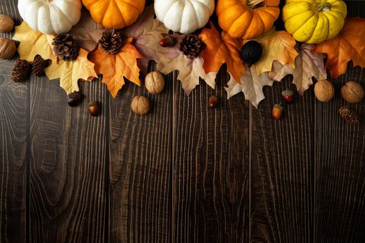 Happy Thanksgiving Day with pumpkin and nut on wooden table