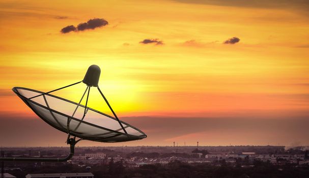 Satellite dish in the city on sunset.