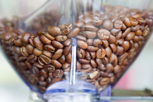 Close-up espresso coffee machine with roasted coffee beans.