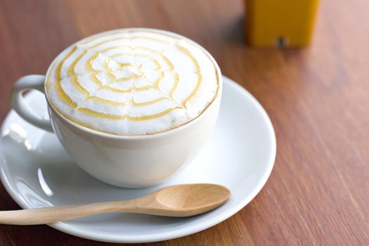 A cup of coffee on wooden table.