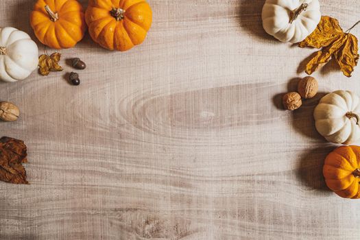 Happy Thanksgiving Day with pumpkin and nut on wooden table