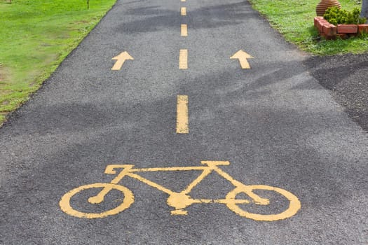 Bicycle sign in public park area.