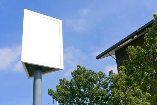 Post sign blank outdoor on the sky and tree.