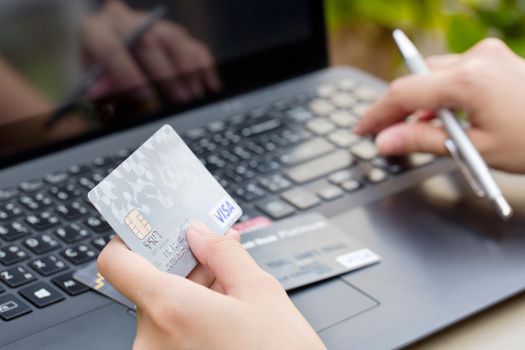 Nakhonratchasima, THAILAND - August 1, 2015 : Credit card VISA brand with pen on keyboard.