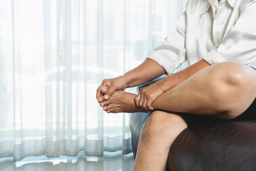 leg cramp, senior woman suffering from leg cramp pain at home, health problem concept