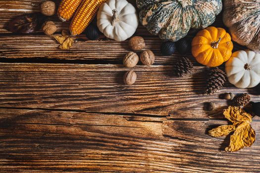 Happy Thanksgiving Day with pumpkin and nut on wooden table