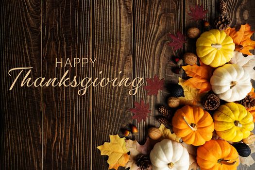 Happy Thanksgiving Day with pumpkin and nut on wooden table