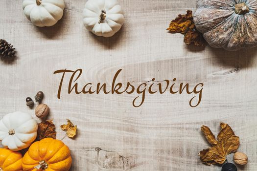 Happy Thanksgiving Day with pumpkin and nut on wooden table