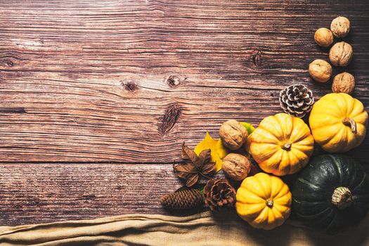 Happy Thanksgiving Day with pumpkin and nut on wooden table